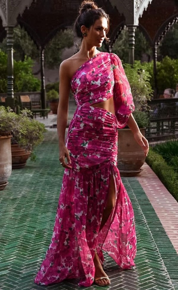 vestido de festa longo com estampa floral. O vestido possui recortes na cintura e possui um ombro só com uma manga bufante