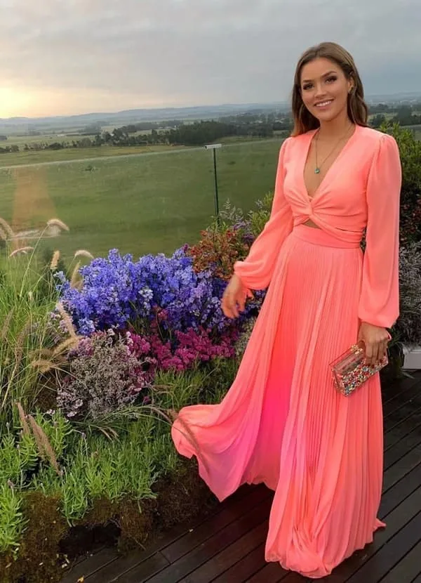 vestido coral com saia plissada e manga longa fluida para convidada de casamento dia